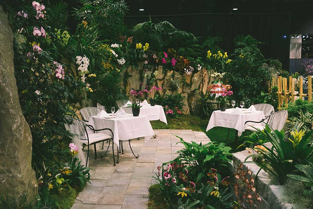 A secluded patio provides a cozy escape among stunning blooms. Photo: Northwest Flower & Garden Show