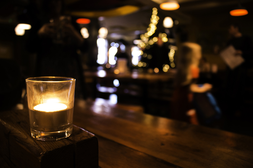 Warm wood and soft lighting lend cabin vibes to the inside of The Cozy Nut Tavern. Photo: Andy Hitchins