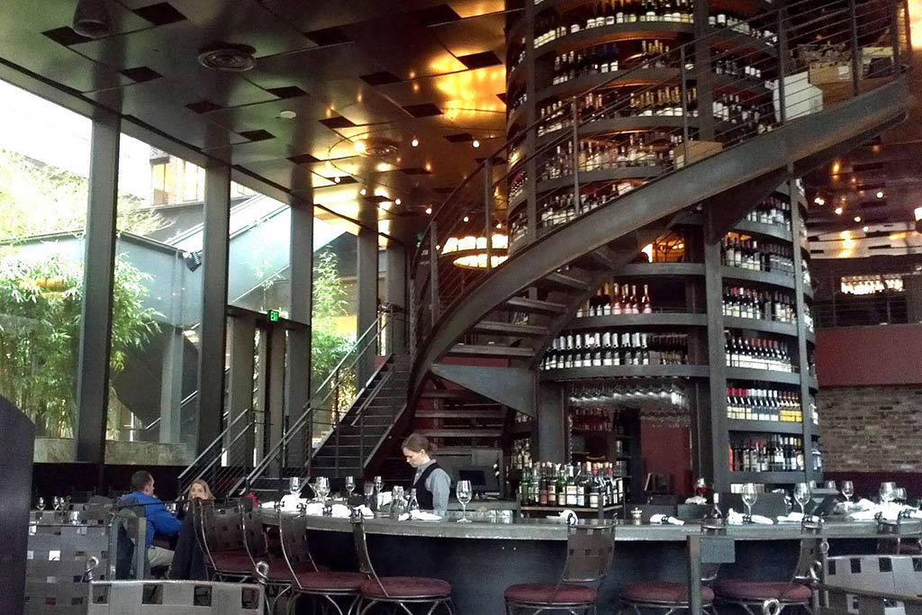 Purple Cafe’s central wine tower and staircase are the centerpiece of the room. Credit: Flickr/tomspix