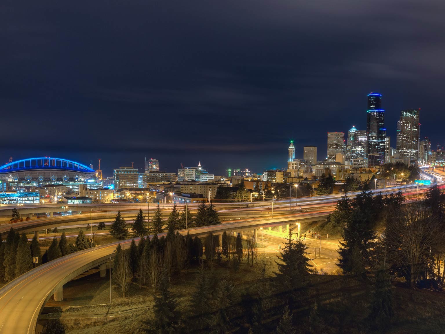 Blue lights illuminate CenturyLink Field and downtown Seattle in honor of the Seahawks game.