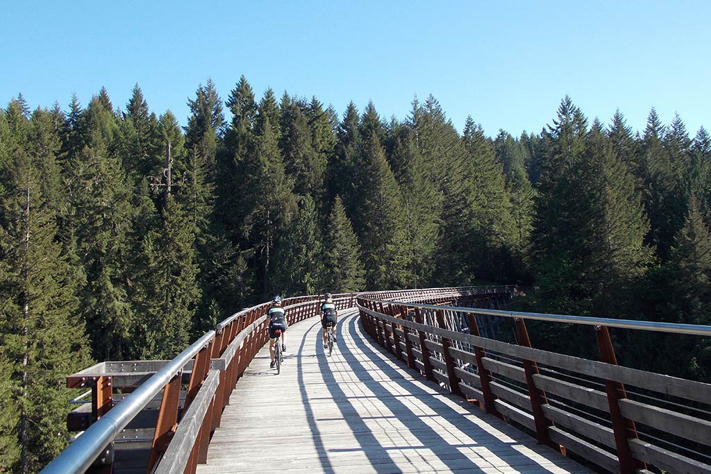 Roll across stunning wooden trestles on the Galloping Goose Trail. Credit: The Pedaler Bicycle Tours