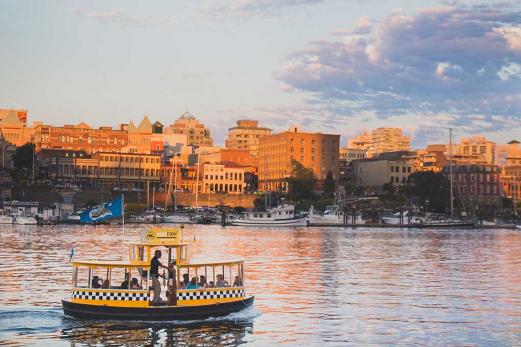 Hop on one of Victoria's cute Harbour Ferries and zip across the Inner Harbour. Credit: Scott Rose