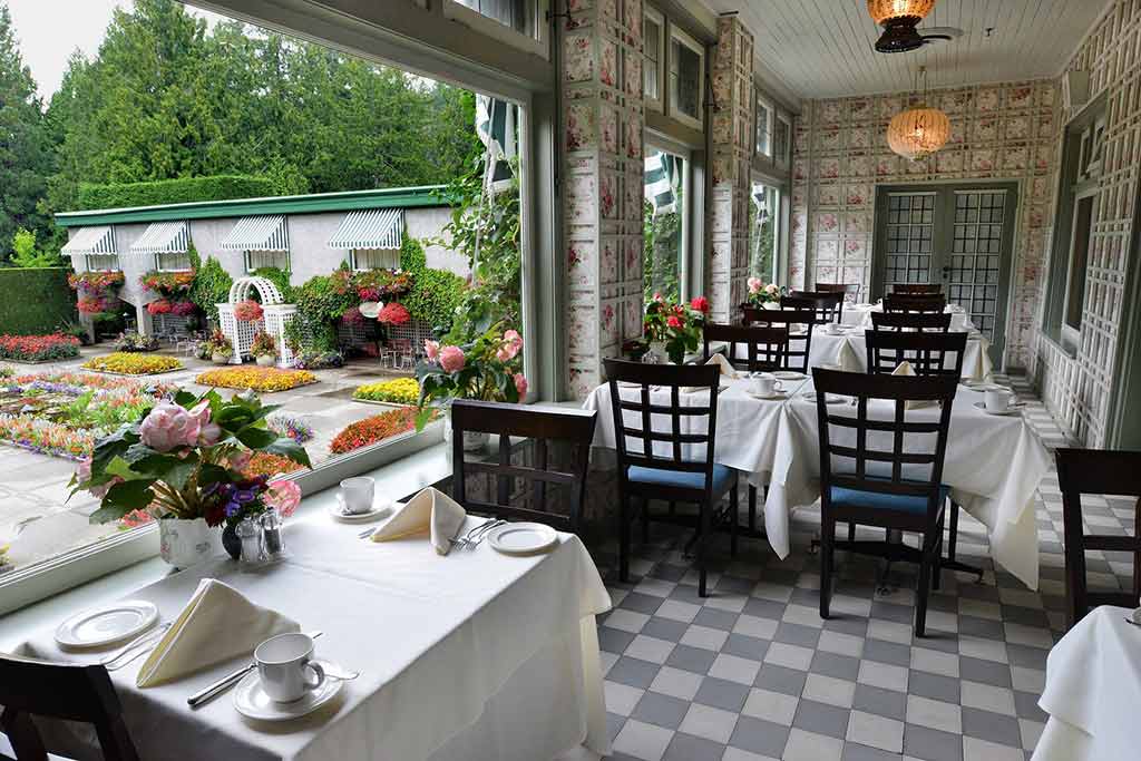 Grab a seat on the Dining Room Restuarant veranda and gaze out at the Italian Garden. Credit: The Butchart Gardens