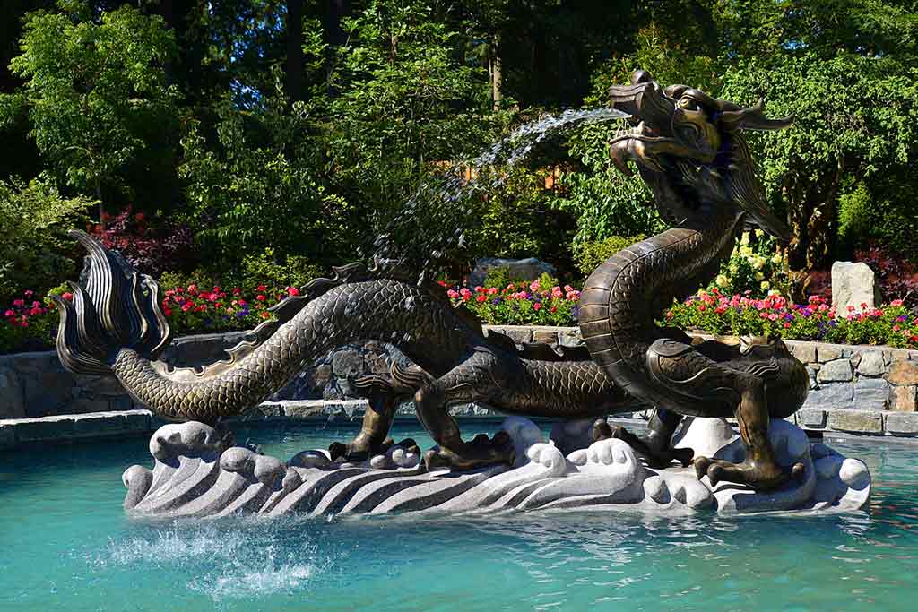 Kick back and relax by the trickling Dragon Fountain. Credit: The Butchart Gardens
