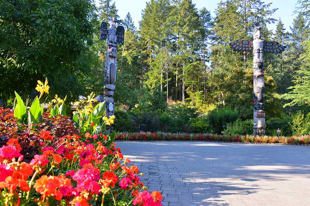 See how many creatures you can spot in these hand-carved totem poles. Credit: The Butchart Gardens