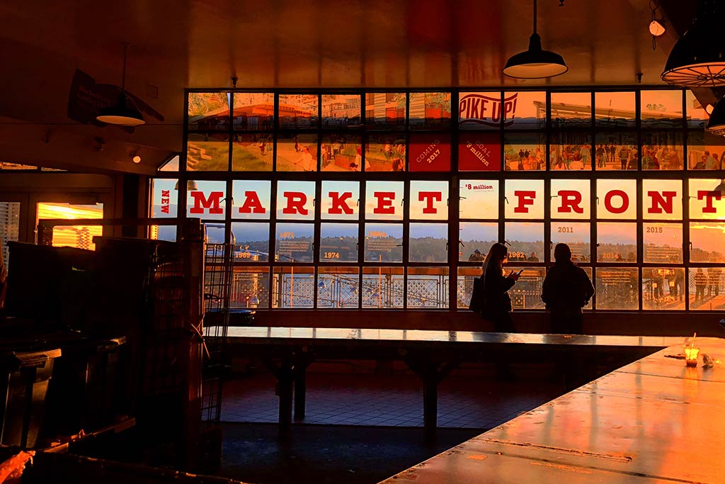 Not only is Pike Place Market home to amazing eats, but it is also a prime spot to soak in a stunning sunset. Credit: Scott Meis