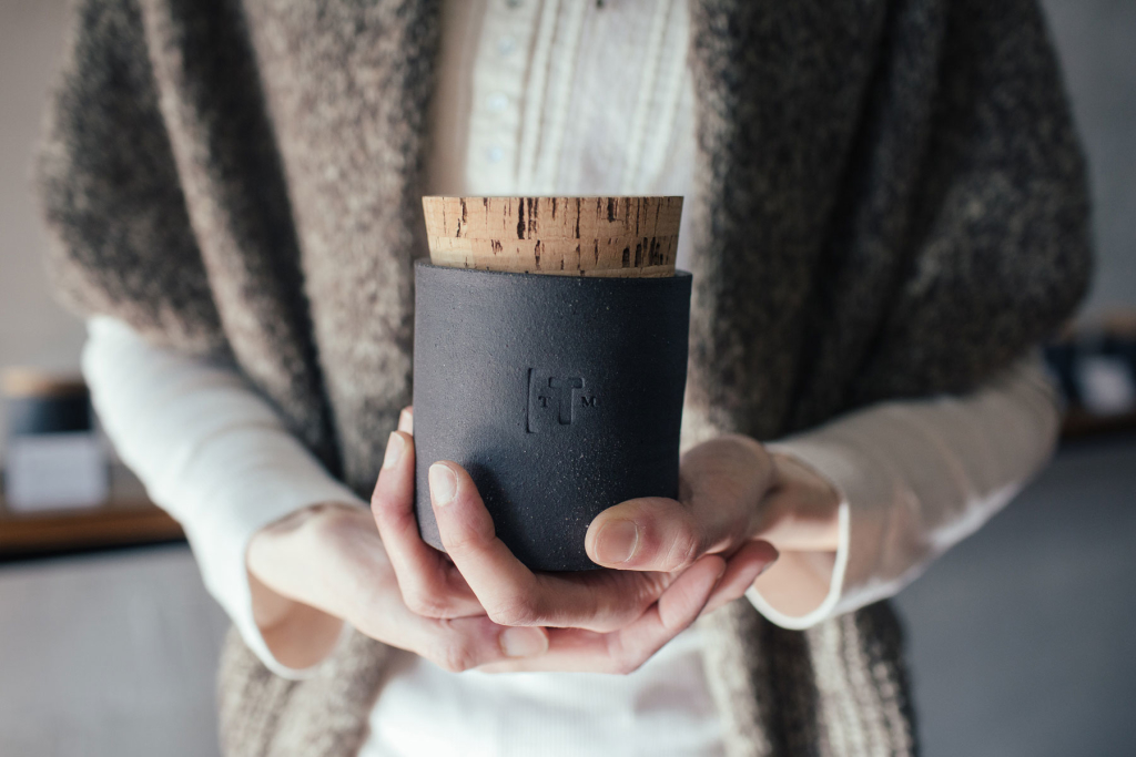 Hobbs holds a sturdy ceramic jar filled with aromatic dried tea. Credit: Lucas Anderson