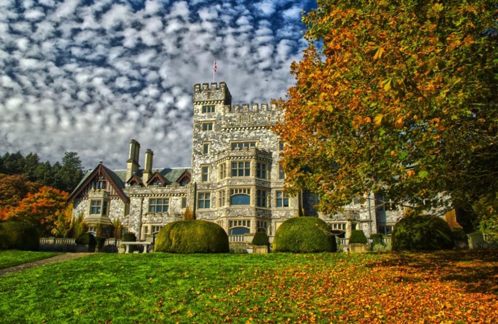 Vivid orange leaves play against a brilliant blue sky at Hatley Castle. Photo: Tourism Victoria