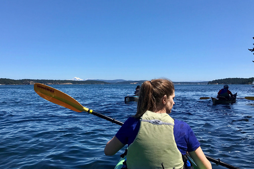 Hugging the shoreline of Brown Island, it is smooth sailing as we paddle through the Salish Sea.