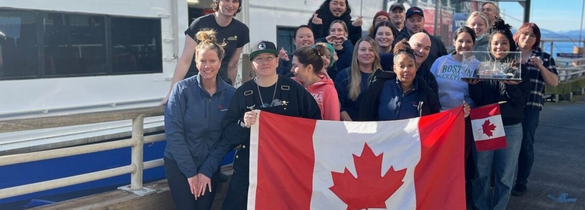 FRS Clipper crew holding up a Canadian flag